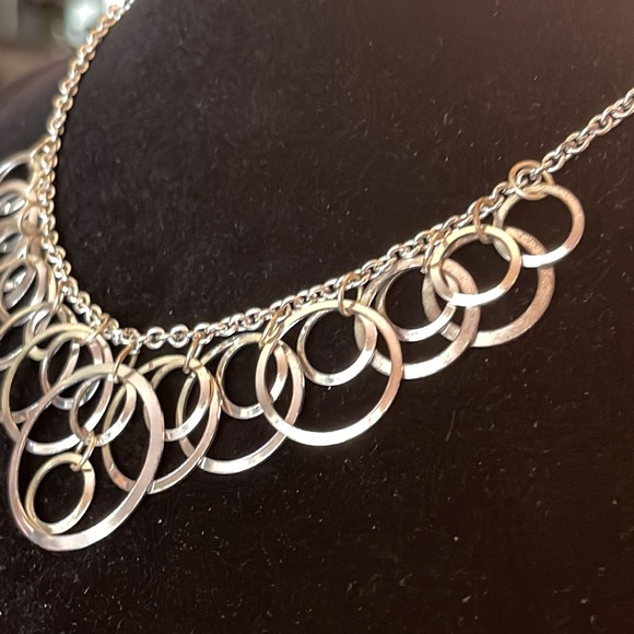 Light silver toned necklace with a variety of circles suspended on silver chain - Picture 10 of 13